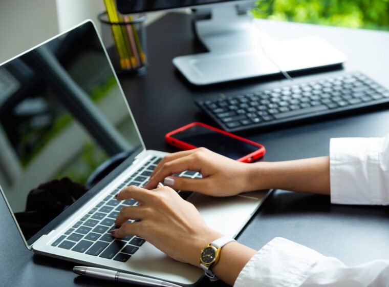 female hand typing keyboard laptop